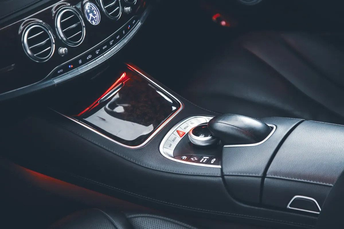 Close-up of a stylish car interior showcasing leather seats and sleek controls.